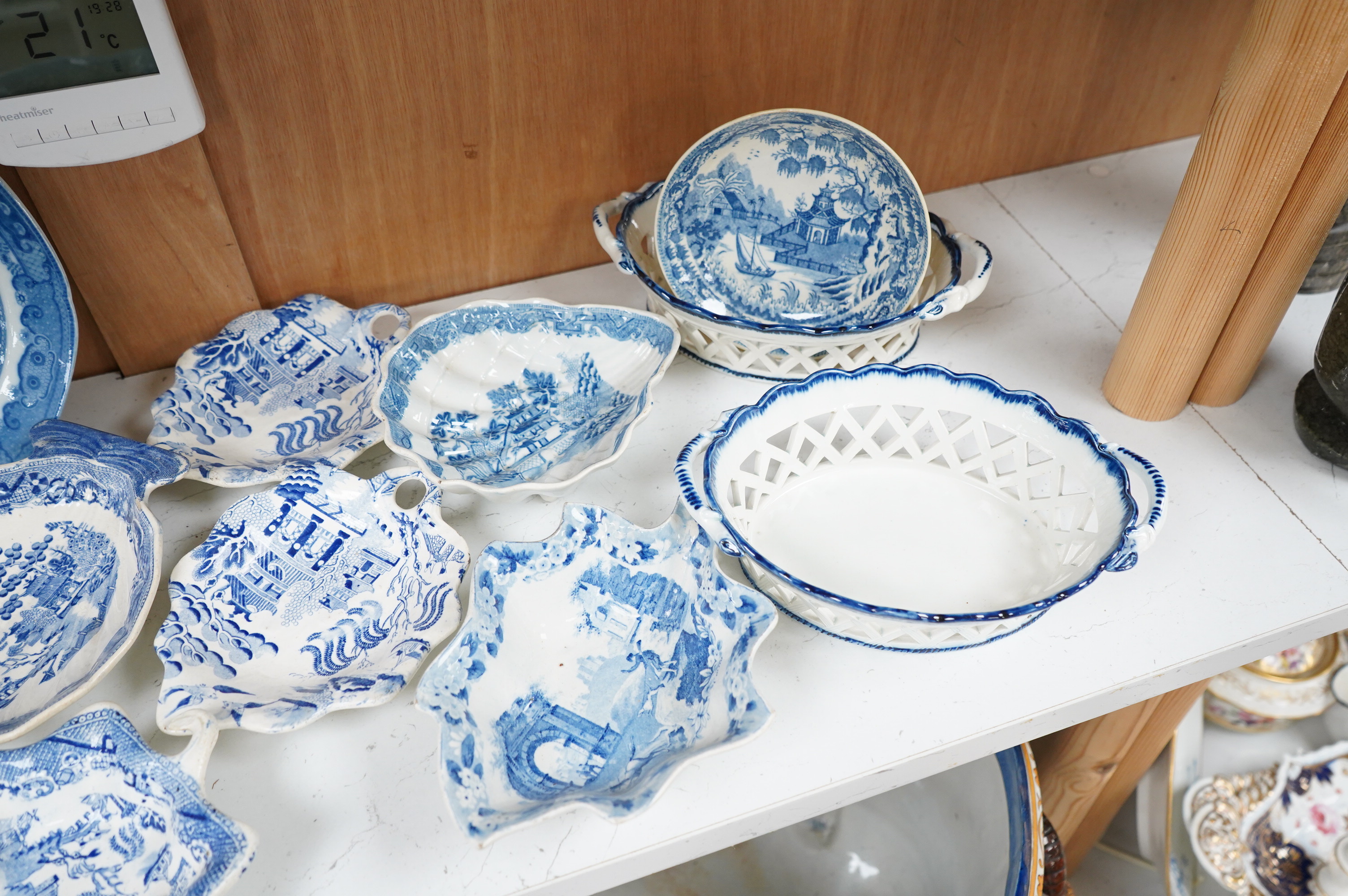 A collection of early 19th century English blue and white pearlware leaf dishes, chestnut baskets, Victorian dolls house dinner service and other pottery
